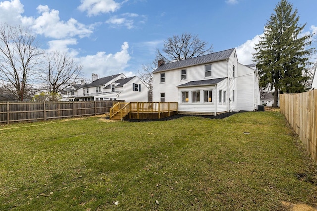 rear view of house with a yard, a deck, and central air condition unit