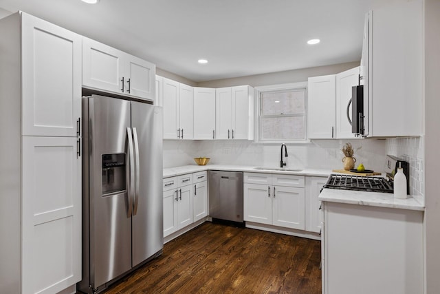 kitchen with white cabinets, sink, dark wood-type flooring, and appliances with stainless steel finishes