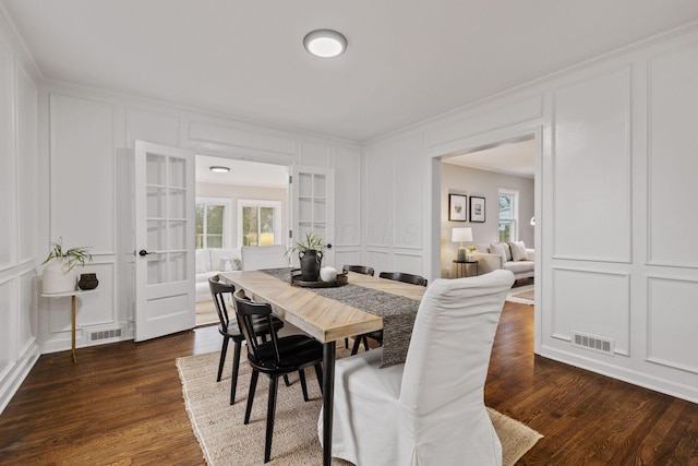 dining room with french doors and dark wood-type flooring