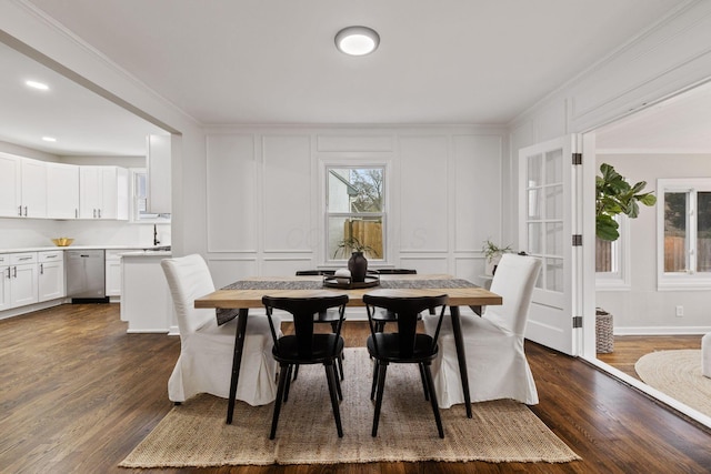 dining space with ornamental molding and dark wood-type flooring