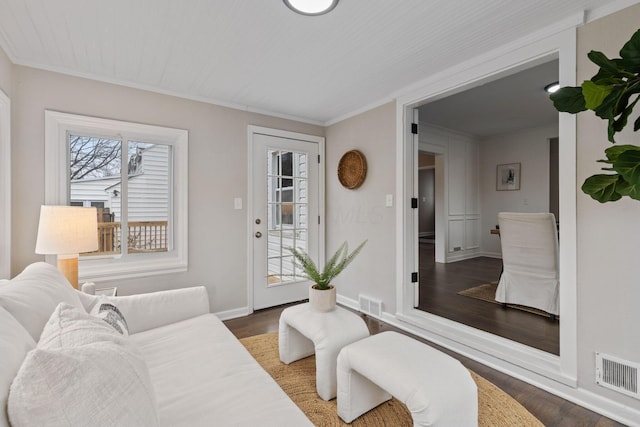 living room with dark hardwood / wood-style floors and ornamental molding