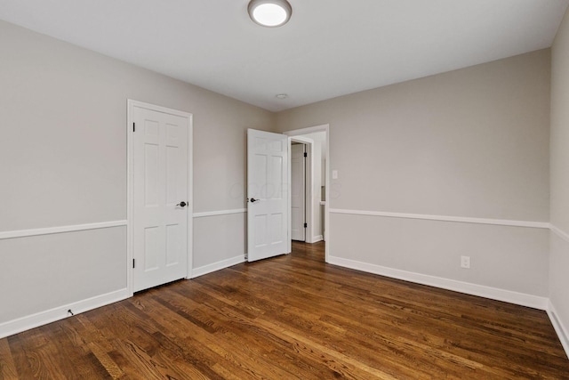 unfurnished bedroom with dark wood-type flooring