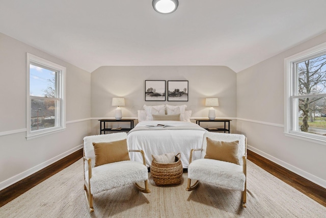 bedroom with dark hardwood / wood-style floors and vaulted ceiling