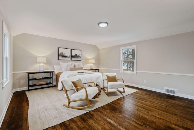 bedroom featuring dark hardwood / wood-style flooring and vaulted ceiling