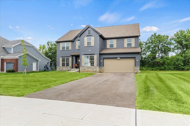 view of front of house with a front yard and a garage