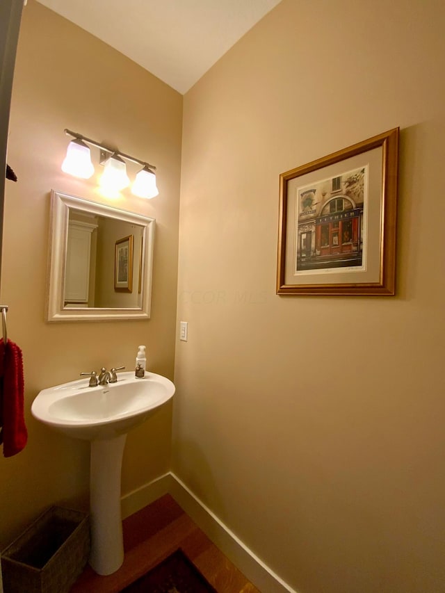 bathroom featuring wood finished floors and baseboards