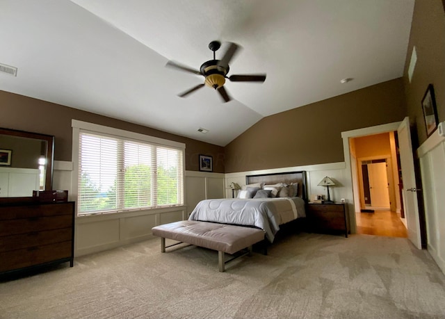 bedroom with ceiling fan, light colored carpet, and lofted ceiling