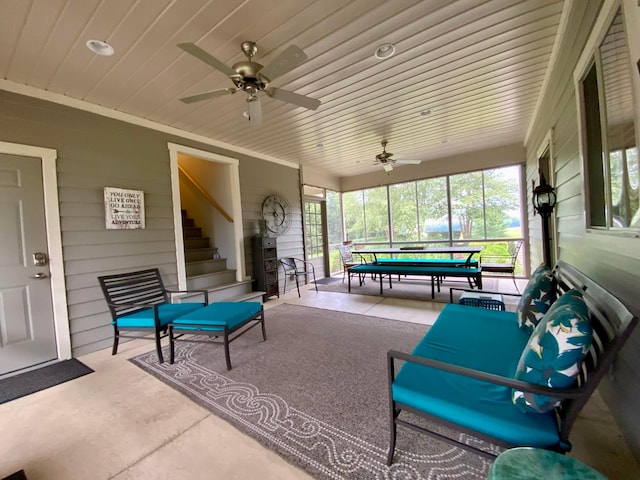 sunroom / solarium featuring ceiling fan and wooden ceiling