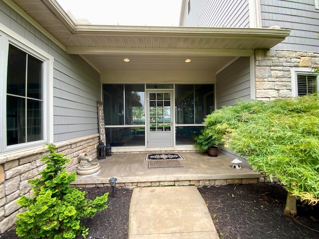 property entrance with stone siding