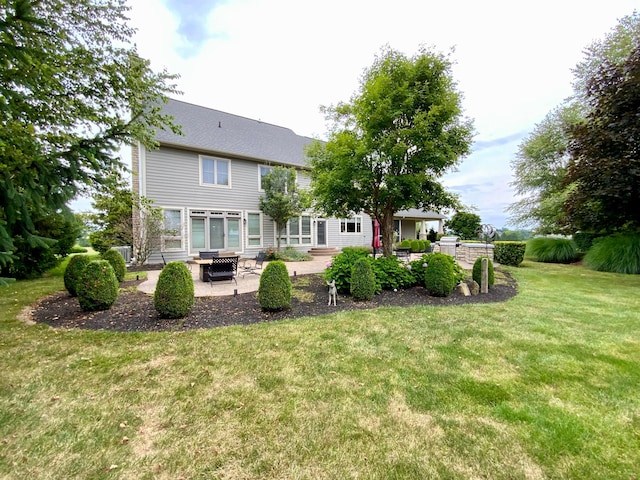 back of property with a lawn and a patio