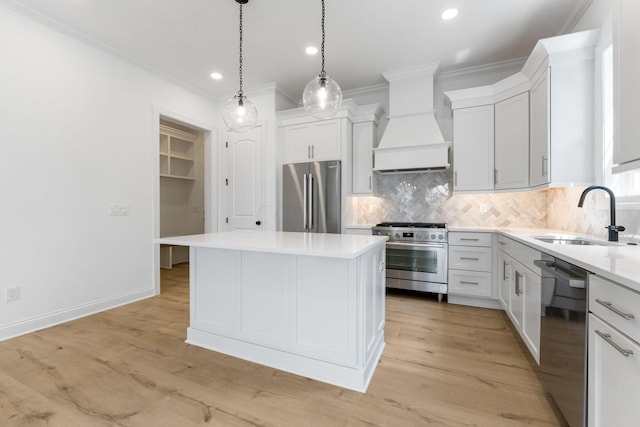 kitchen featuring white cabinetry, sink, a center island, premium range hood, and high quality appliances