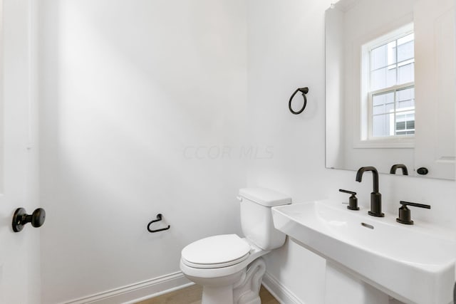 bathroom featuring sink and toilet