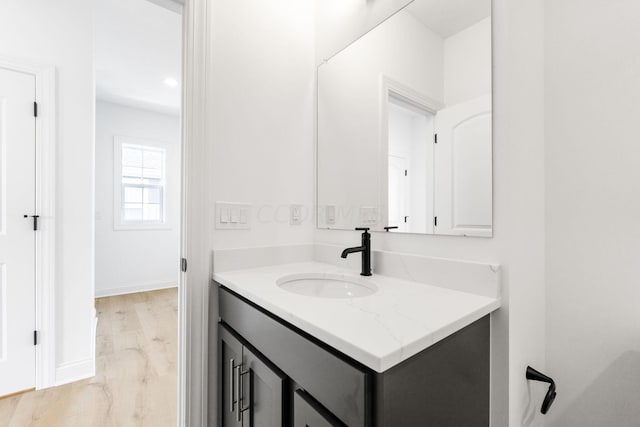 bathroom with vanity and hardwood / wood-style flooring