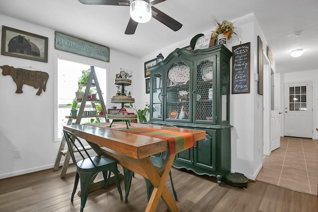 dining area with ceiling fan and wood-type flooring