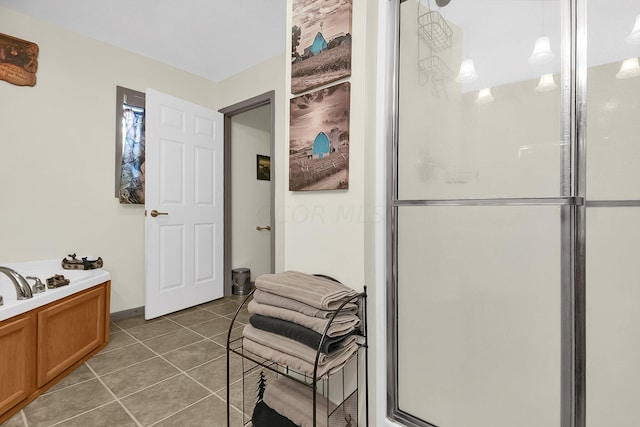 bathroom featuring tile patterned floors and separate shower and tub