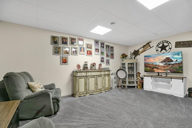 interior space with a drop ceiling and carpet floors