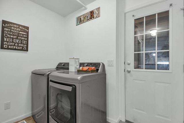 laundry room featuring separate washer and dryer and tile patterned flooring