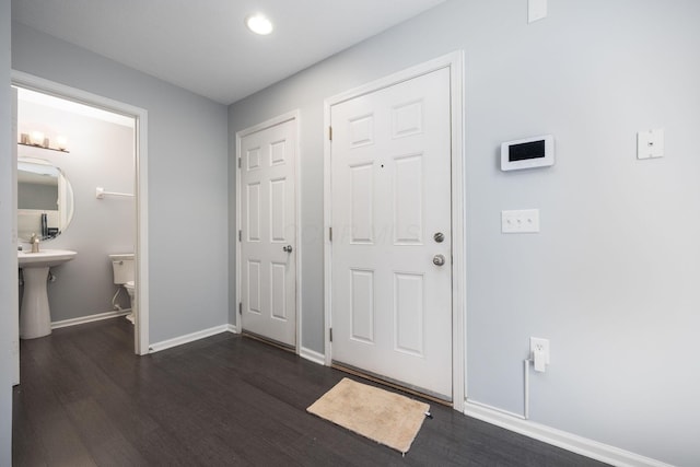 entrance foyer featuring dark hardwood / wood-style flooring and sink