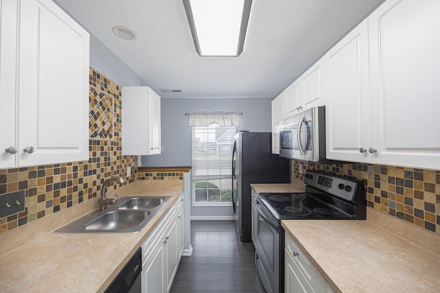 kitchen with backsplash, white cabinetry, sink, and stainless steel appliances