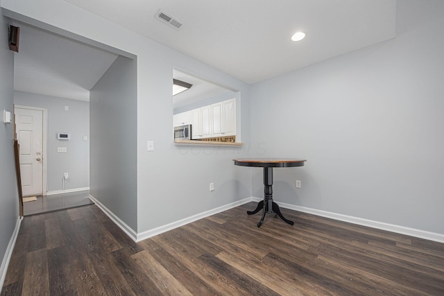 corridor featuring dark wood-type flooring