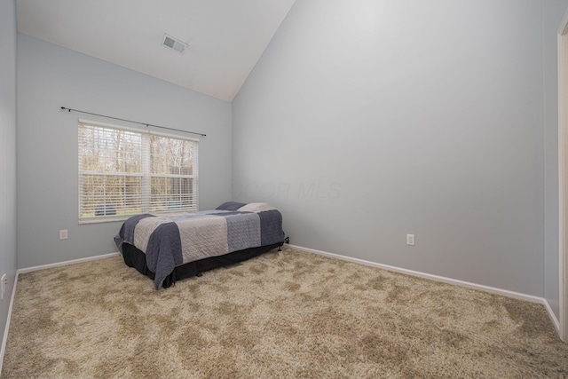 carpeted bedroom with vaulted ceiling