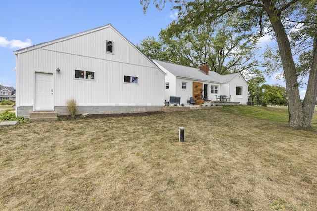 rear view of house with a yard