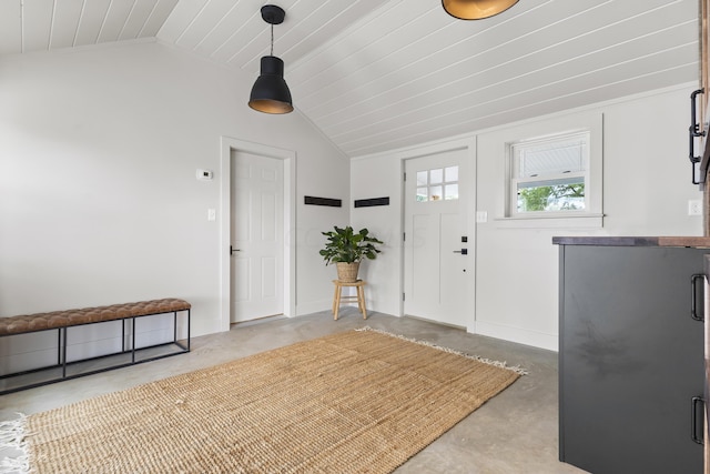 foyer with concrete floors and vaulted ceiling