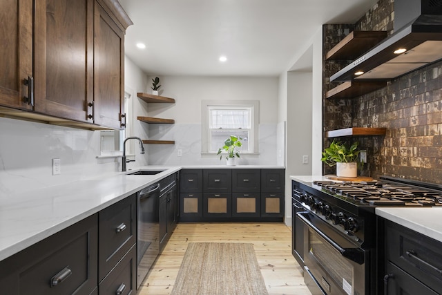 kitchen featuring decorative backsplash, wall chimney exhaust hood, light hardwood / wood-style floors, dishwasher, and stainless steel stove