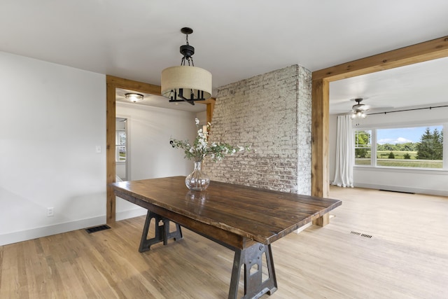 dining space featuring ceiling fan and light wood-type flooring