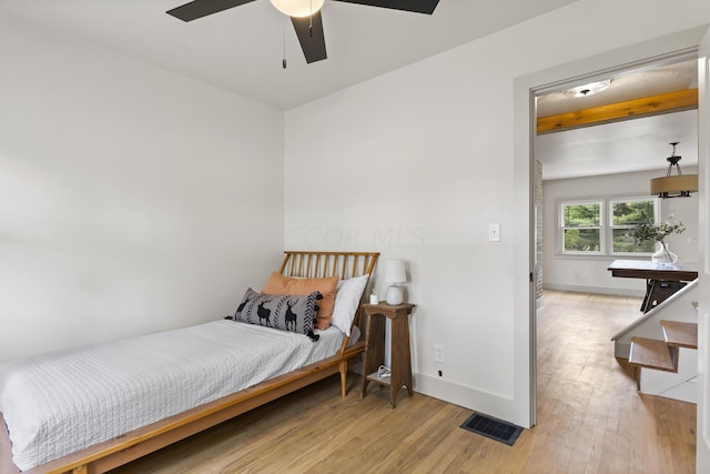 bedroom with ceiling fan and light hardwood / wood-style floors