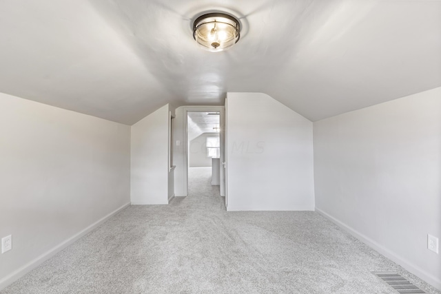 bonus room with carpet floors and lofted ceiling