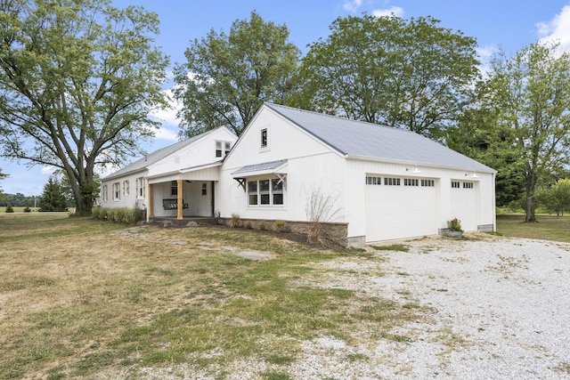 modern farmhouse style home with a front lawn and a garage