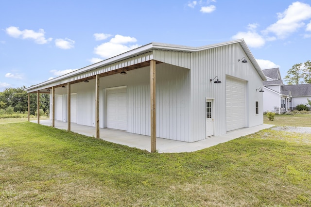 exterior space with a yard, an outdoor structure, and a garage