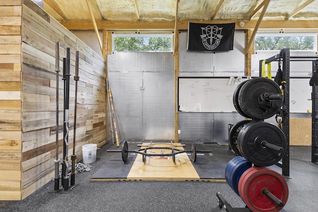 exercise room featuring wood walls