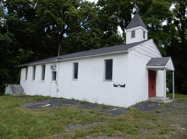160 Commerce St, Lockbourne, OH 43137 - view of home's exterior featuring stucco siding and an AC wall unit