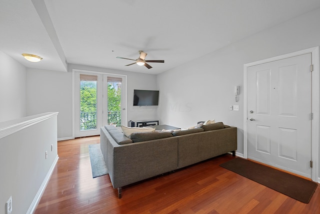 living room featuring hardwood / wood-style flooring and ceiling fan