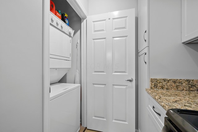 laundry room with stacked washer / dryer