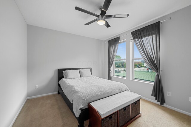 carpeted bedroom with ceiling fan