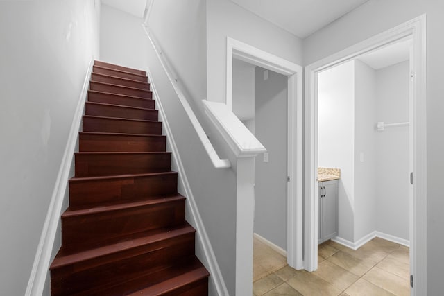 stairway featuring tile patterned flooring