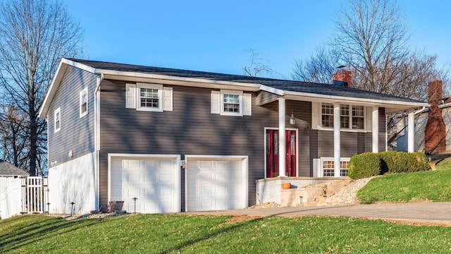 raised ranch with a front yard and a garage