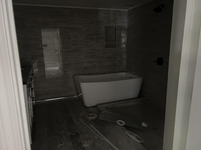 bathroom with tile walls and toilet