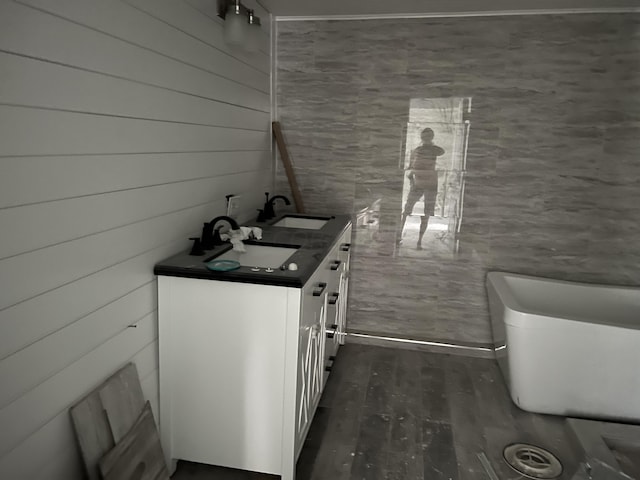 interior space featuring wood-type flooring, vanity, and toilet