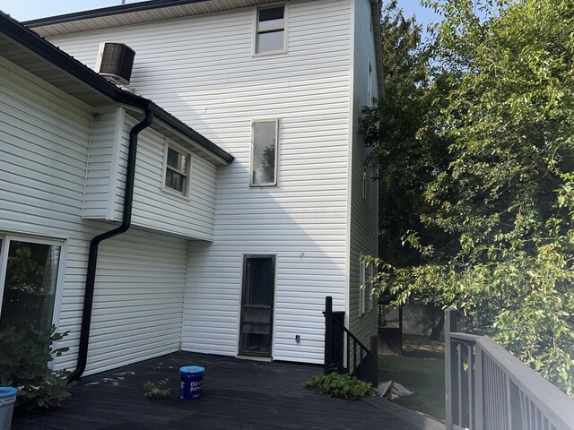 back of house featuring a wooden deck