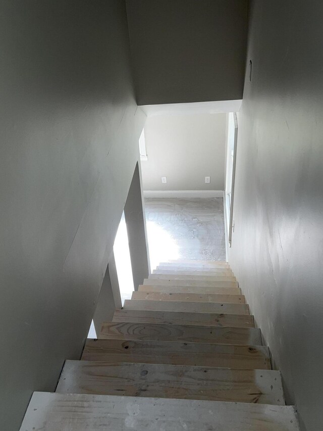 stairs featuring hardwood / wood-style floors