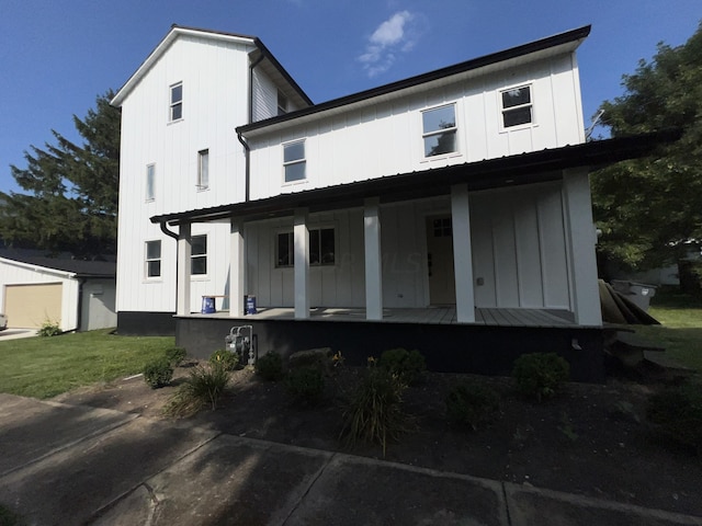 back of property featuring covered porch