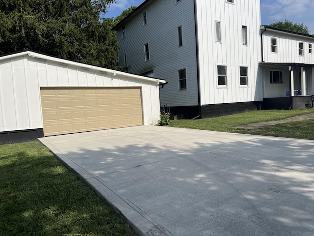 view of side of property featuring a yard and a garage