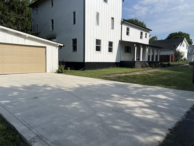 view of home's exterior with a lawn and a garage