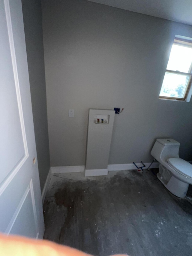 bathroom with wood-type flooring and toilet