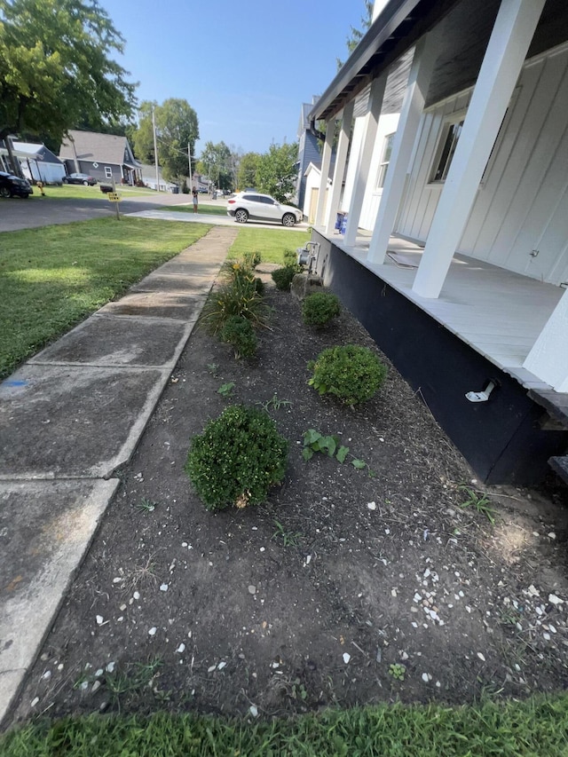 view of yard featuring covered porch