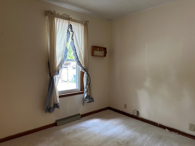 carpeted spare room with baseboard heating